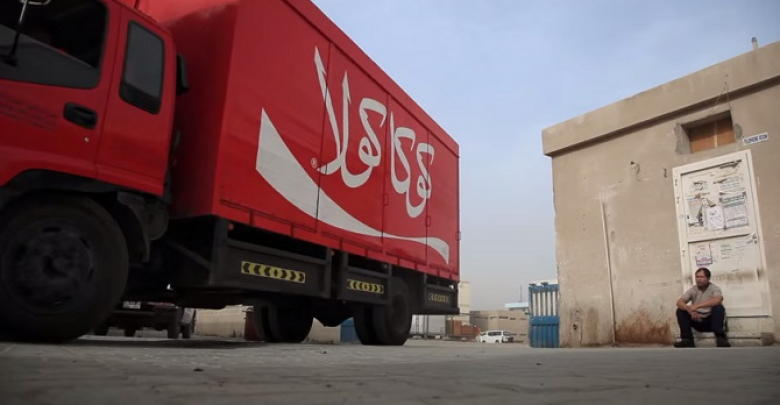 Coke deliver happiness Asian workers in Dubai